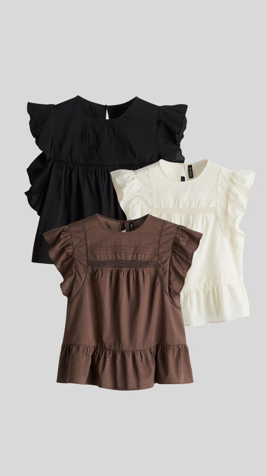 Blusa con inserciones de encaje y peplum
